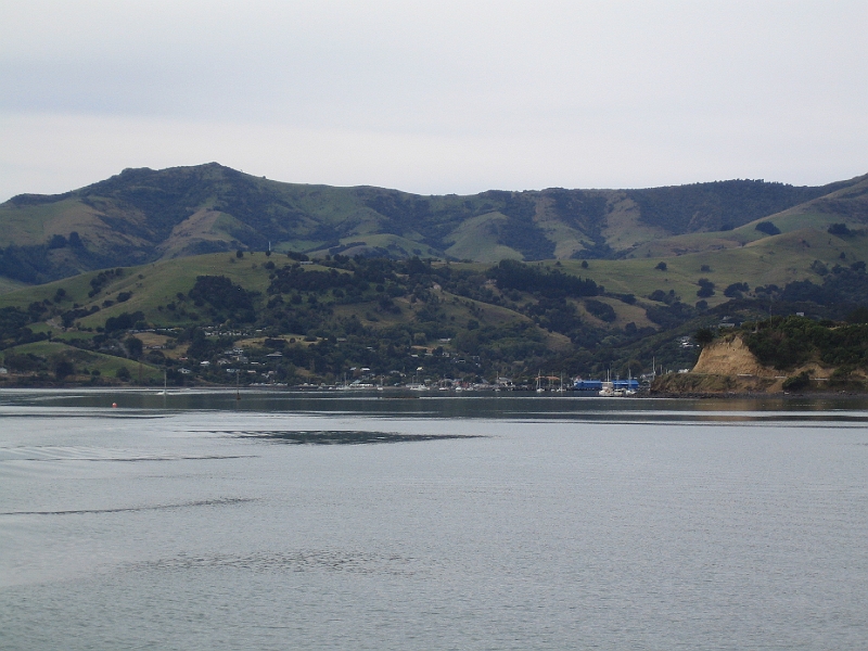 IMG_2063.JPG - Looking back at Akaroa - past the Britomart Memorial (cliffs on right)